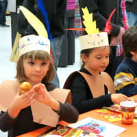 <p>Increase Miller Elementary School first-graders Helena, left, and Andrea enjoyed seasonal snacks at the annual Thanksgiving feast.</p>
