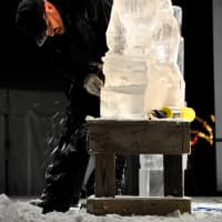 <p>Watching an ice sculpture being created at the Winter Wonderland festivities.</p>