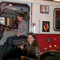 <p>Anna Manfredi, left, and Maddie Manfredi, of North White Plains, get a tour of the North White Plains Firehouse.</p>