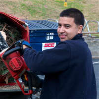 <p>Robinson Galeano of White Plains works the chainsaw trimming tree trunks at the North White Plains Firehouse.</p>