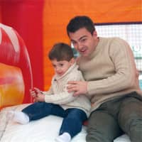 <p>Joe Licare of Rye, with his uncle, Marty Gennusa, of NYC, enjoy the slide on the bouncy house.</p>
