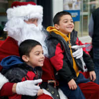 <p>Ray Granda, left, and Max Granda 5-year-old twins from Rye Brook, enjoy their visit with Santa.</p>