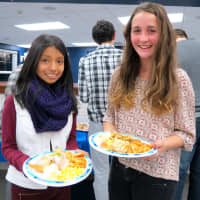 <p>Croton-Harmon High School TAP students fill their plates with Thanksgiving food.</p>