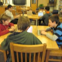 <p>Students work together collectively in the library. </p>