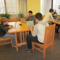 <p>Students work in the library. </p>