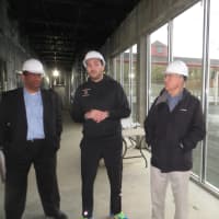 <p>White Plains Recreation and Parks Director, far left, stands inside the future tennis clubhouse with Cesar Andrade, director of operations. Mayor Tom Roach is on the far right.</p>