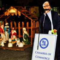 <p>New Rochelle Chamber of Commerce Director Bob Marrone flanked by a manger scene.</p>