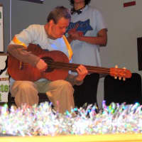 <p>Bobby Vento of Norwalk performs with guitar at Theater of STARs.</p>