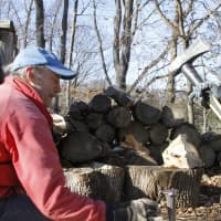 <p>Paul Warren of Somers, left, assists Eric Bilodeau, right, in chopping wood for  the church&#x27;s donation-based wood sale. Families are encouraged to take what they need, while leaving whatever they are able to give in return. </p>