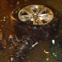 <p>The impact of the crash knocked the left front wheel off the SUV.</p>