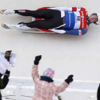 <p>Fans cheer as Tucker West slides past them at Lake Placid.</p>