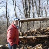 <p>Paul Warren watches the kids chopping extra wood.</p>