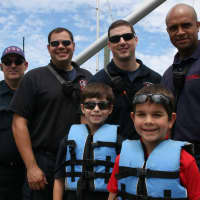 <p>Nick and J.P. Lobuono pose with first responders from the Stamford Fire Department.</p>