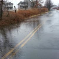 <p>The roadway is covered with water Tuesday morning along Fairfield Beach Road. </p>