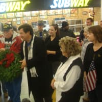 <p>Karen Worcester of Wreaths Across America presents a wreath to Paul Landino of Project Service at the service plaza on I-95 Southbound in Darien.</p>