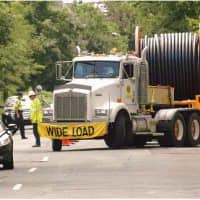 <p>Traffic moves on South State Street as the electrical cable is pulled into new conduits under the street during construction.</p>