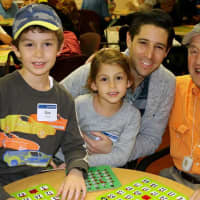 <p>The Goldfein family of New Rochelle play bingo with a Kittay House resident.</p>