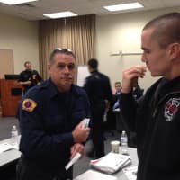 <p>Yonkers Firefighter Chris Leal assisting Probationary Firefighter Steven Roche with swabbing his cheek to register for the program.
</p>