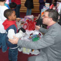 <p>Vinnie Fusco general manager and executive in charge of production at NBCUniversals Stamford Media Center talks with Gemere McIntosh, 6, during a toy donation by NBCUniversal staff in Stamford on Wednesday.</p>