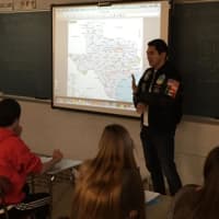<p>Alvarado gives a presentation to a class.</p>