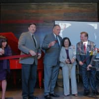 <p>Berkshire Hathaway HomeServices River Towns Real Estate officials and county executives on stage at the Hudson Room during the ceremonial ribbon-cutting ceremony.</p>