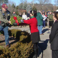 <p>Alice Ridgeway, Connecticut state vice regent of the Daughters of the American Revolution, and Katherine Love, regent of the Good Wife&#x27;s River chapter of the DAR, hand David Polett a remembrance wreath in honor of POW and MIA soldiers.</p>