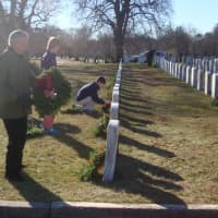 <p>Darien volunteers lay wreaths and pause to reflect during the Wreaths Across America ceremony.</p>