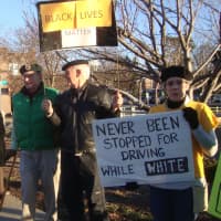 <p>Protesters on both sides of the bridge in downtown Westport held up signs and protested the treatment of African Americans by police Saturday.</p>