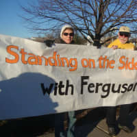 <p>Protesters hold a large banner at the rally in Westport.</p>
