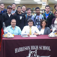 <p>Sal LoMedico of Harrison High School (center of table) will play lacrosse for Southern New Hampshire University in 2015.</p>