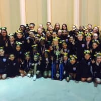 <p>The Norwalk Packers under-13 and under-10 cheer teams celebrate after winning national titles.</p>