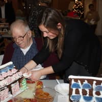 <p>A volunteer from UBS helps a gentleman at Waveny LifeCare Network in New Canaan.</p>