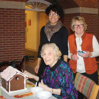 <p>UBS volunteers celebrate the successful completion of a gingerbread house at Waveny LifeCare Network in New Canaan.</p>