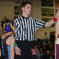 <p>Colin Falla of the Norwalk Mad Bulls youth wrestling team has his arm raised after winning a match in New Milford. Falla was among 21 Norwalk wrestlers to place at the meet.</p>