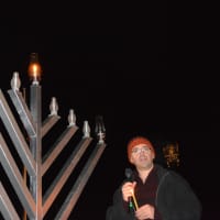 <p>Somers resident Jim Laredo stands next to the menorah prior to lighting the candle for the first night.</p>