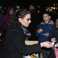 <p>Rabbi Sarah Freidson-King of Mahopac&#x27;s Temple Beth Shalom distributes items at the Somers Hanukkah celebration.</p>