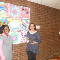 <p>Leslie Harrison and Kathy Yacoe Skura stand in front of a collage quilt inspired by Faith Ringgold&#x27;s book &quot;Tar Beach.&quot;</p>