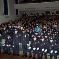 <p>The 138th basic police recruit class at Friday&#x27;s graduation. The officers standing were recognized for prior military service.</p>