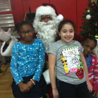 <p>Santa Clause showed up at the Stamford Boys &amp; Clubs Club Friday during the club&#x27;s annual holiday dinner. From left are: Jasmine Stroud, 8, Santa, Melisa Aguirre, 9, and Zenayn Dixon, 8.</p>
