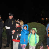 <p>Village of Mamaroneck police officers stand with some of their children during a vigil Monday night.</p>