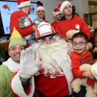 <p>Buddy the Elf, left, with Santa Claus at John A. Coleman School.</p>