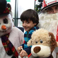 <p>Each child at John A. Coleman school received a stuffed animal from Frosty and Santa.</p>