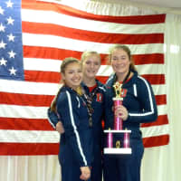 <p>Darien Level 8 gymnasts Perri Mirabile, Jessica Freiheit and Sam Gunn won the first place team trophy at the Snowflake Invitational meet in Wilton. Mirabile also won the All Around title for her age group.</p>