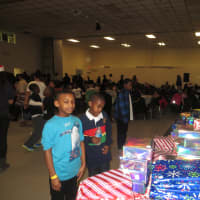 <p>White Plains children check out the presents before they were handed out by Batty&#x27;s Kids on Christmas Eve.</p>