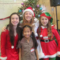 <p>Sadie Gilman, Acadia Theilking, Esther Thielking and Lily Gilman as elves at the holiday dinner in Katonah.</p>