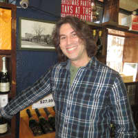 <p>Jake Lambertson, wine buyer and manager at Post Wine and Spirits in Larchmont, poses next to his favorite champagne, Philippe Prie. </p>