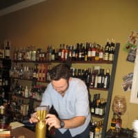 <p>A salesman at Wine at Five wraps a bottle of bubbly on Saturday.</p>
