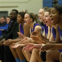 <p>New Rochelle girls cheer teammates from bench.</p>