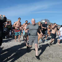 <p>Those taking the plunge get a running start on Compo Beach. </p>