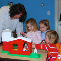 <p>Catherine Cardone, Alice Miller and Libby Hennemuth enjoy the Toddler Time program with teacher Emily Engongoro at the YWCA Darien/Norwalk. </p>